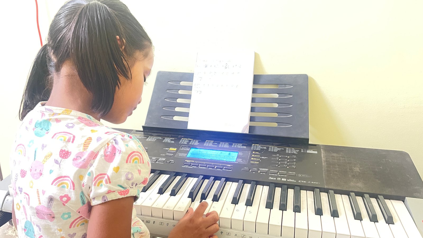 Student playing keyboard at Three Stars International Music Academy