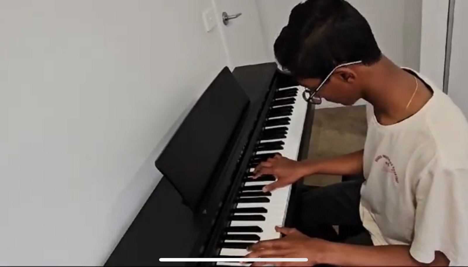 Student learning piano at Three Stars International Music Academy