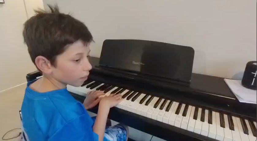 Student practicing piano at Three Stars International Music Academy